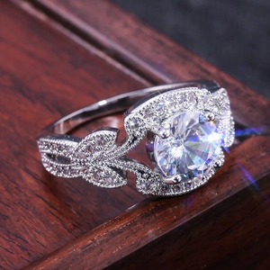 Vintage leaf design silver ring with large round cut simulated diamond in a regal style
