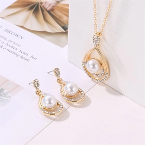Detailed view of pearl jewelry set with drop shaped necklace and matching stud earrings