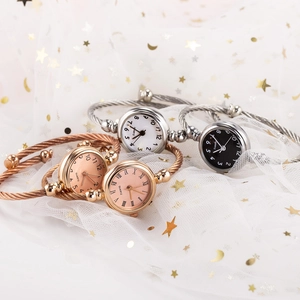 Elegant bangle watches with twisted rope bands in rose gold and silver on white tulle