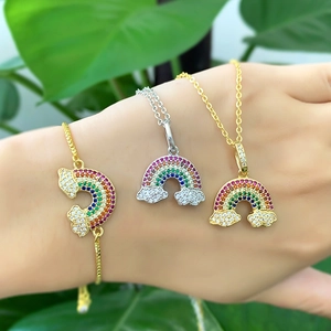 Detail of rainbow jewelry set with cubic zirconia bracelet and cloud necklaces on model