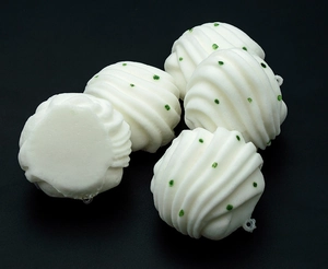 Detailed close-up of spiral PU squishy bun toy with green dots and clear hanging loop