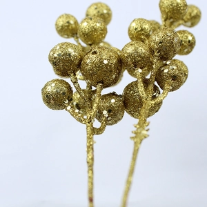 Macro detail of artificial Christmas gold glitter berries for festive home decoration