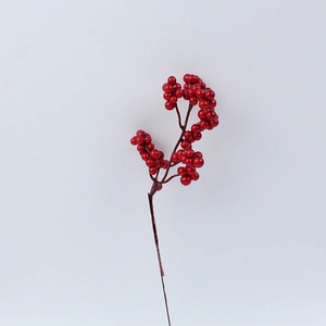 Close-up of glossy artificial red berries branches for Christmas home decoration