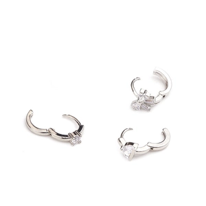 Detailed view of silver hoop earrings featuring micro-pave cubic zirconia in various shapes