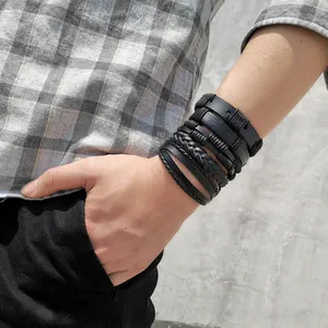 Close-up of black multilayer leather bracelets featuring woven cords and smooth bands