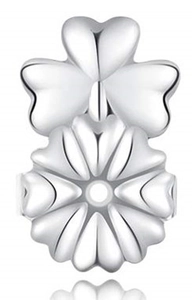 Macro shot of silver clover-shaped earring lifters with polished metallic finish