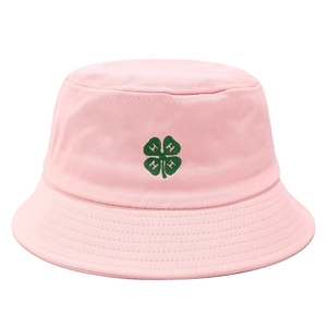 Close-up of pink cotton bucket hat featuring green four-leaf clover and H embroidery