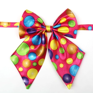 Vibrant rose red dog bow tie with colorful polka dots on glossy satin fabric