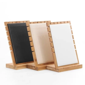 Detailed view of bamboo necklace displays in black beige and white padded textures