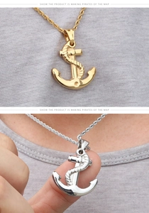 Detail view of gold and silver anchor pendants on classic twisted rope chains
