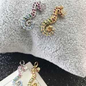 Detailed view of colorful seahorse pendants with zircon pave-setting and gold plating