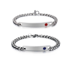 Detail of silver medical alert bracelets with red and blue medical symbols on white backdrop
