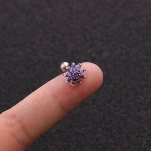 Macro shot of purple zircon flower stud earring with silver base and ball screw back