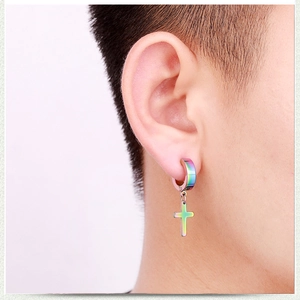 Close-up of rainbow gradient stainless steel cross hoop earring on ear model side view