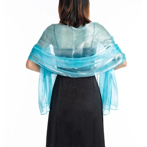 Detailed back view of a sheer blue bridal shawl draped over a black evening dress