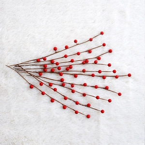Pastoral red berry stems on white plush background for Christmas tree home decoration
