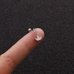 Macro shot of silver stainless steel cartilage stud with marquise zircon leaf pendant