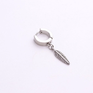 Detailed close-up of a silver stainless steel earring with a carved feather pendant
