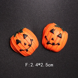 Macro detail of pumpkin resin charms for Halloween DIY crafts with size markings