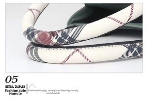 Detailed macro view of the cream leather handle with red and grey plaid pattern texture