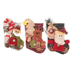 Three decorative Christmas stockings featuring Santa, snowman and reindeer on white background