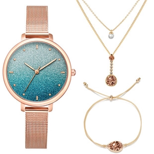 Detailed set of rose gold watch with blue dial, layered necklace, and charm bracelet