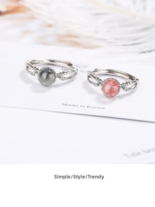 Detailed close-up of adjustable pink strawberry crystal and grey moonstone rings