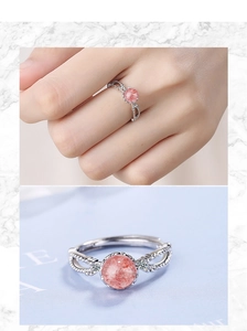 Macro detail of a silver ring with pink strawberry crystal and sparkling side stones