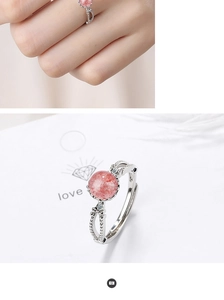 Detail view showing a pink strawberry quartz ring with sparkling side stones on a model