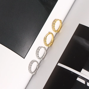 Close-up of small S925 sterling silver hoop earrings in gold and silver with zircon stones