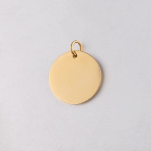 Macro shot of a polished gold stainless steel round charm with a smooth mirror finish