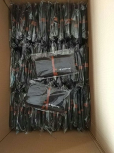 Bulk pack of black felt storage bags with U OPTIC logo inside a shipping box
