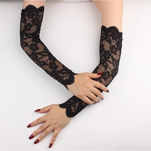 Close-up of long black lace sun protection sleeves with intricate floral patterns