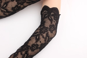 Close-up of black lace arm sleeves with floral patterns and scalloped edges for sun protection