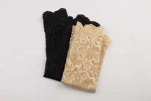 Close-up of floral lace cooling arm sleeves in black and beige with scalloped edges
