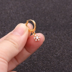 Detailed close-up of a golden sunflower earring with sparkling zircon flower pendant