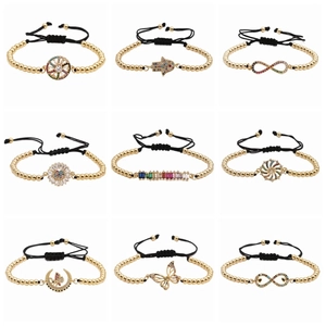 Adjustable gold bead bracelets with colorful zircon pendants on white background