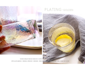 Detailed view of iridescent hammered texture glass with gold plating and lemon slices