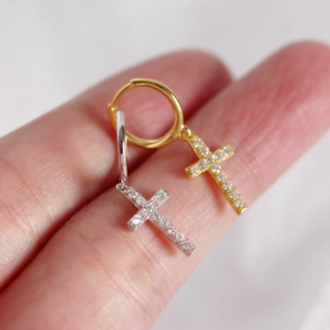Close-up of gold and silver S925 sterling silver cross hoop earrings with inlaid diamonds