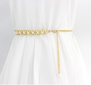 Close-up of golden pearl waist chain with intricate metal weaving and lobster clasp