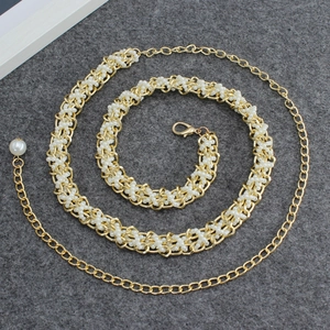 Close-up of golden metal chain with white imitation pearls and adjustable lobster clasp