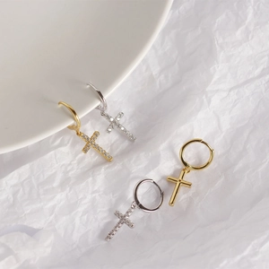 Macro shot of silver and gold S925 sterling silver cross earrings with cubic zirconia inlay