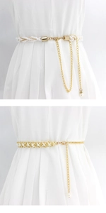 Close-up of elegant pearl metal waist chain with gold links on a white dress