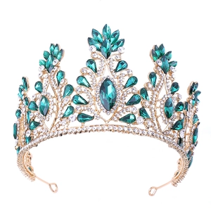 Elegant gold bridal tiara with green and clear crystals for a royal wedding look