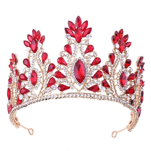 Macro shot of gold wedding tiara featuring ruby red crystals and sparkling rhinestones