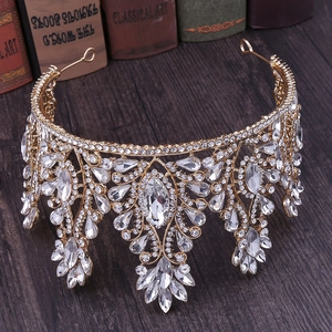 Close-up of golden bridal crown with crystals on a dark wood background