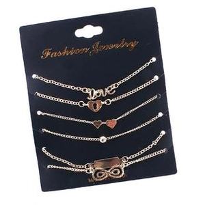 Detail of 5-piece gold bracelet set with Love, heart, and infinity symbol charms