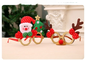 Close-up of festive Christmas glasses with Santa Claus, deer antlers, and glitter details