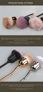 Detailed view of rose-shaped makeup brush with soft bristles and metallic leaf handle