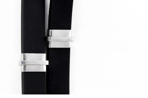 Detail view of black silicone strap with rectangular metal accents for men's bracelet